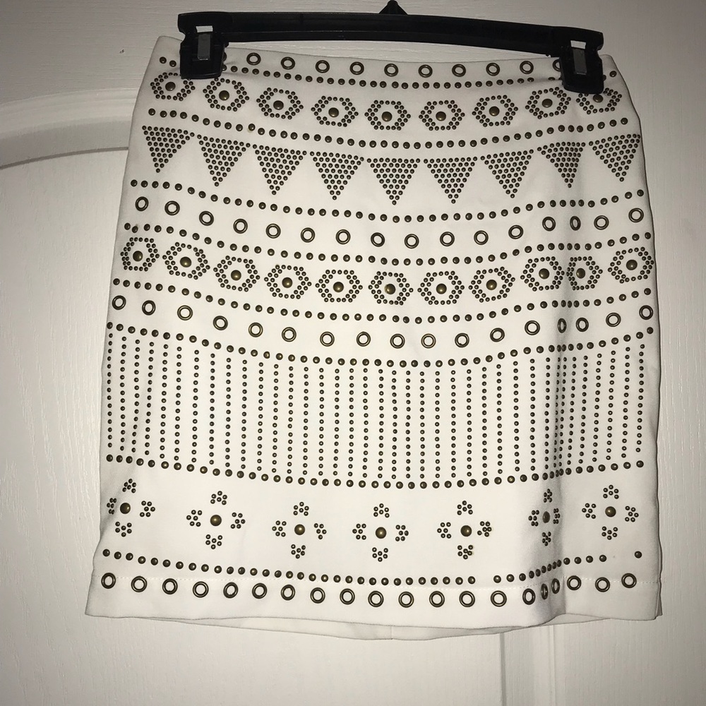 Tight, white mini skirt with gold embellishments